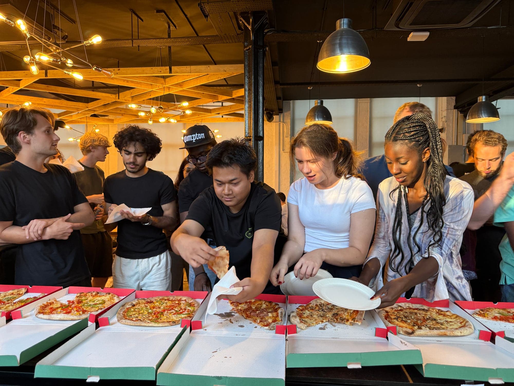 A crowd of HackerSquad attendees sharing food between sessions